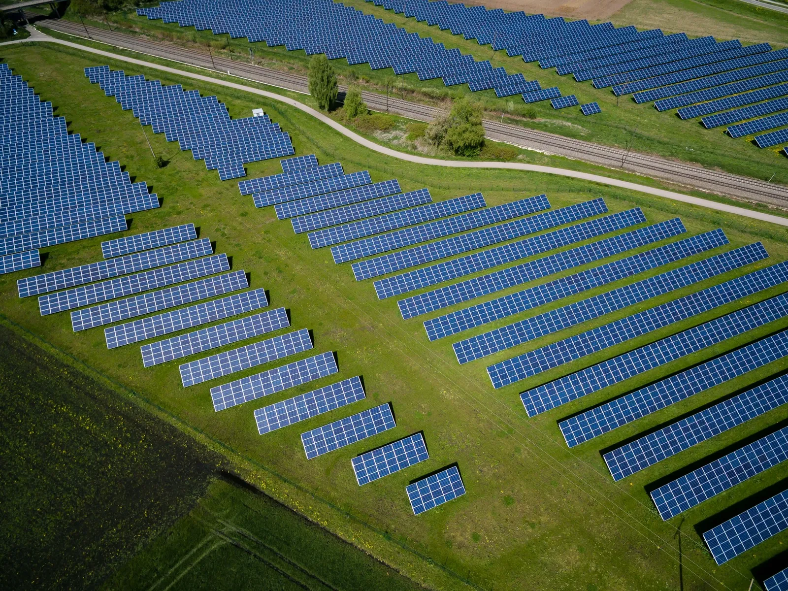 Aerial view of a solar array across green fields