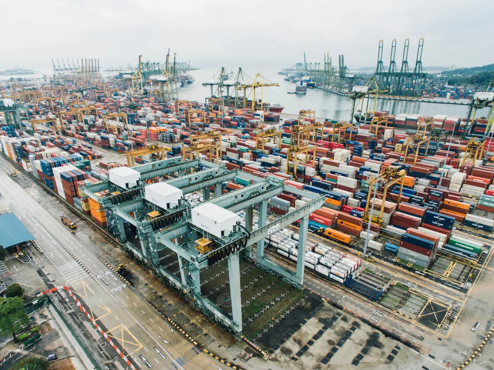 A container terminal seen from above, with stacked containers and cranes