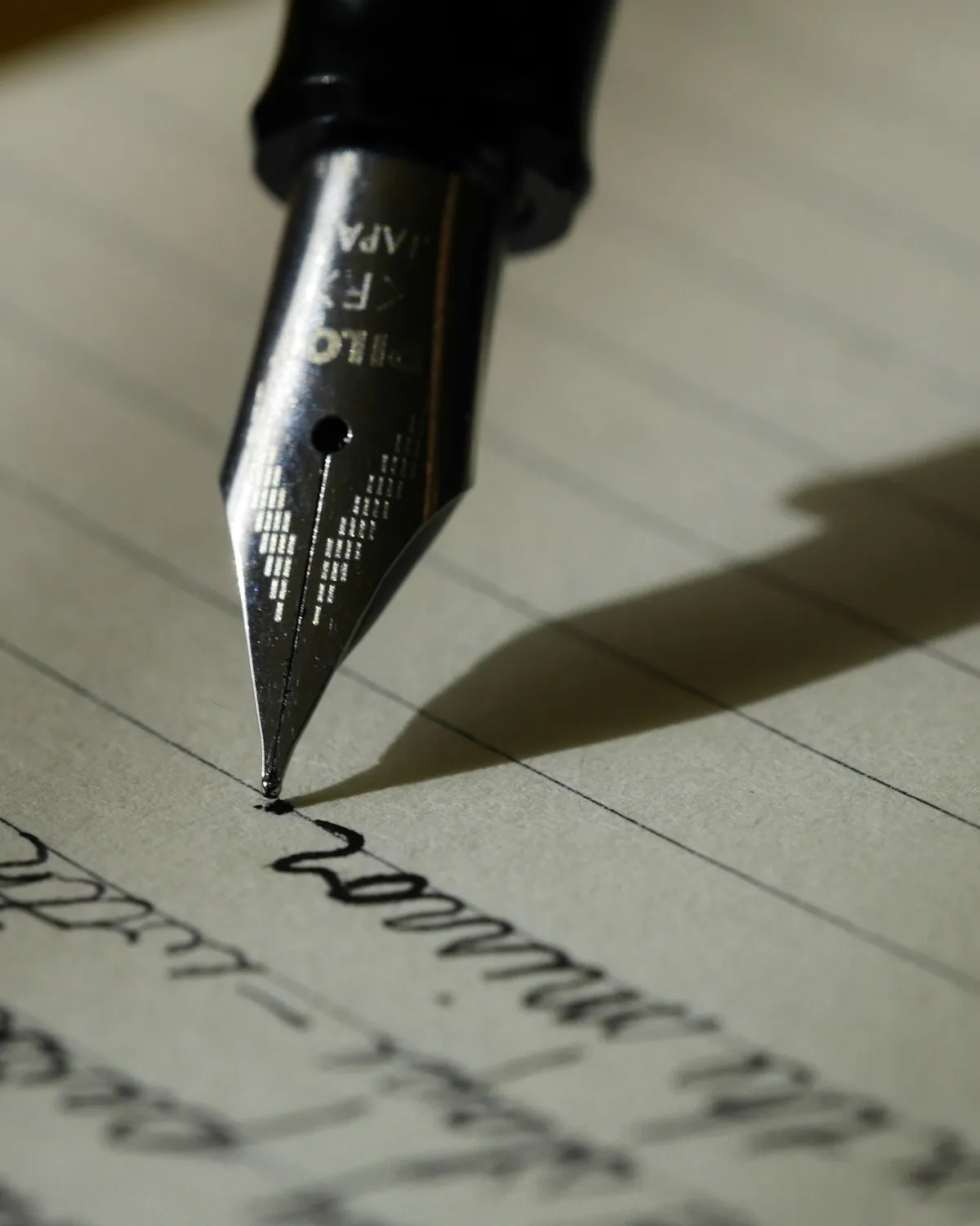 Hand writing with a fountain pen on paper