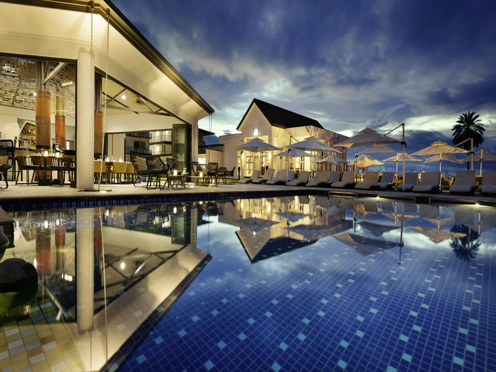 Resort pool with loungers and palm trees